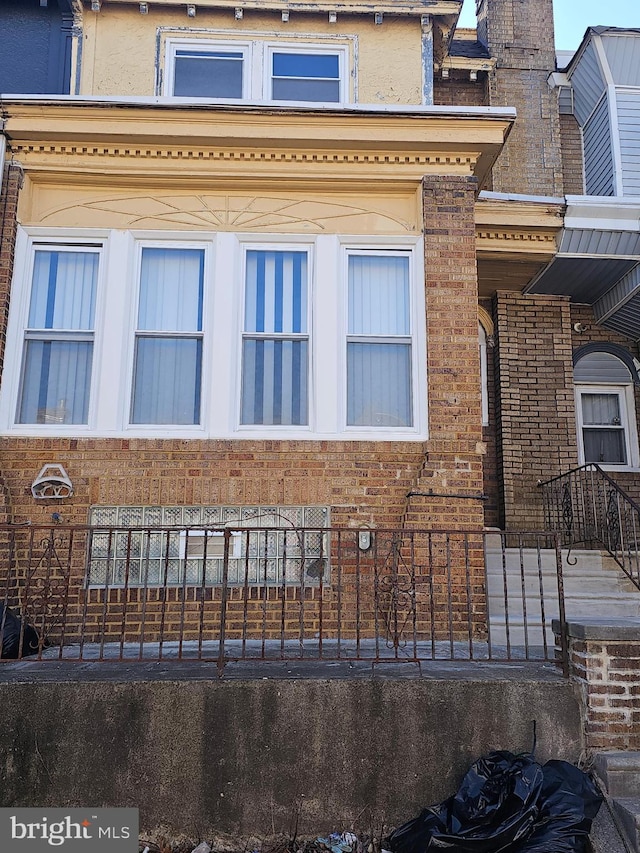 view of side of home featuring brick siding