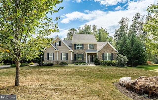 view of front of home featuring stone siding and a front lawn