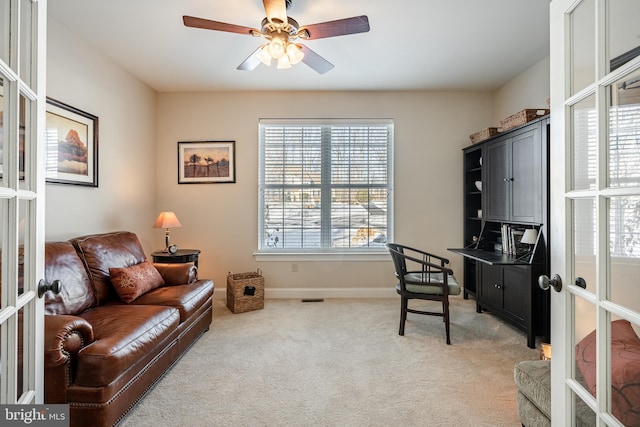 office with ceiling fan, light colored carpet, visible vents, baseboards, and french doors