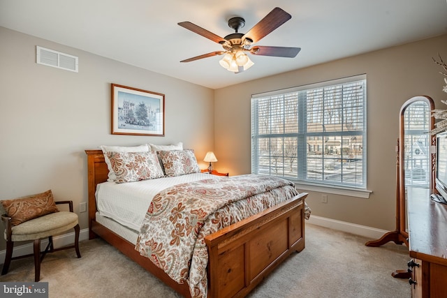 bedroom with baseboards, visible vents, a ceiling fan, and light colored carpet