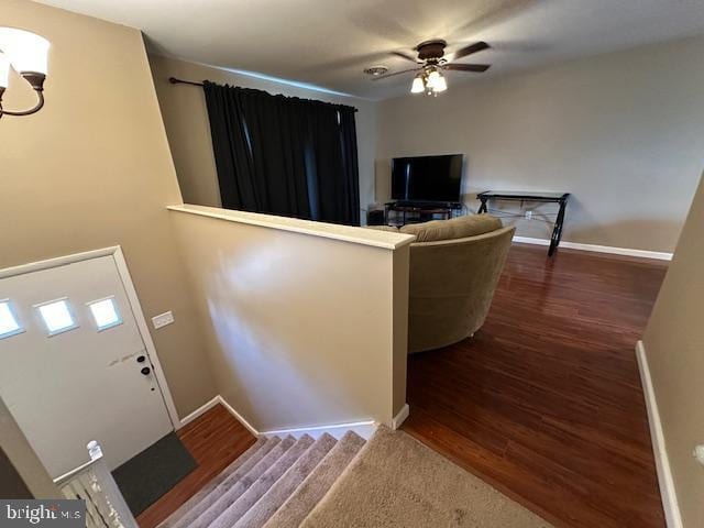 foyer featuring ceiling fan, baseboards, and wood finished floors