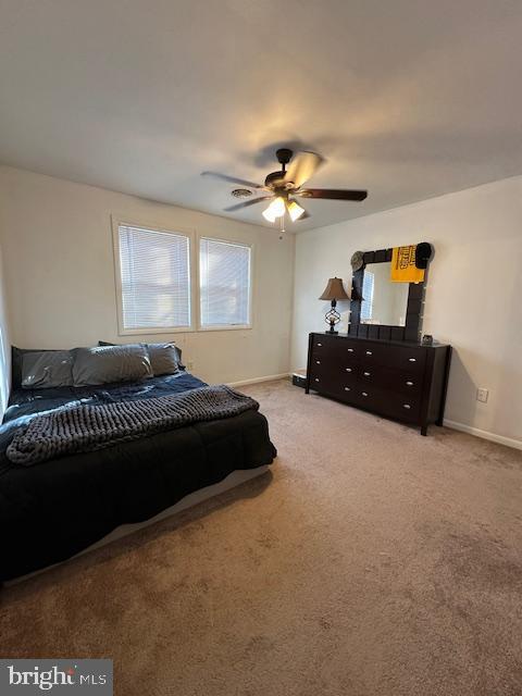 bedroom featuring baseboards, carpet, and ceiling fan