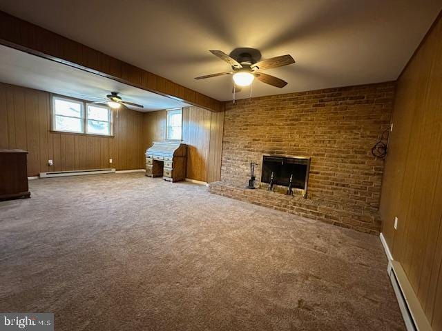 unfurnished living room featuring carpet, a fireplace, wood walls, a baseboard heating unit, and baseboard heating