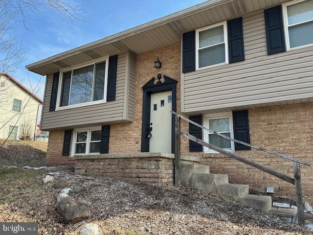 property entrance featuring brick siding