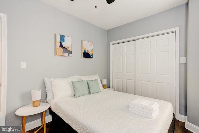 bedroom with ceiling fan, a baseboard heating unit, a closet, and baseboards