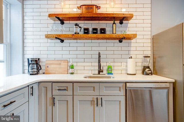 bar with freestanding refrigerator, dishwasher, backsplash, and a sink