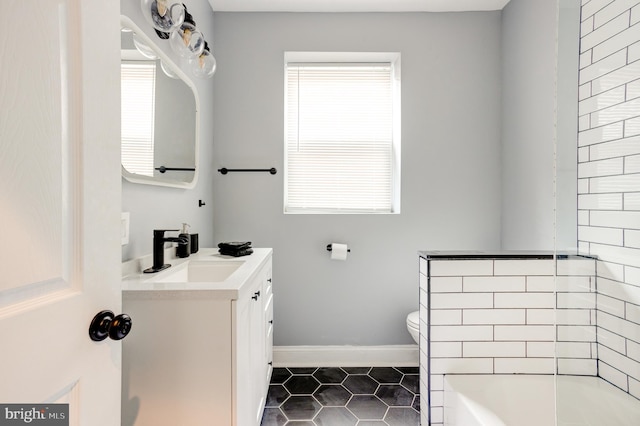 full bath featuring baseboards, toilet, tile patterned flooring, vanity, and a bath