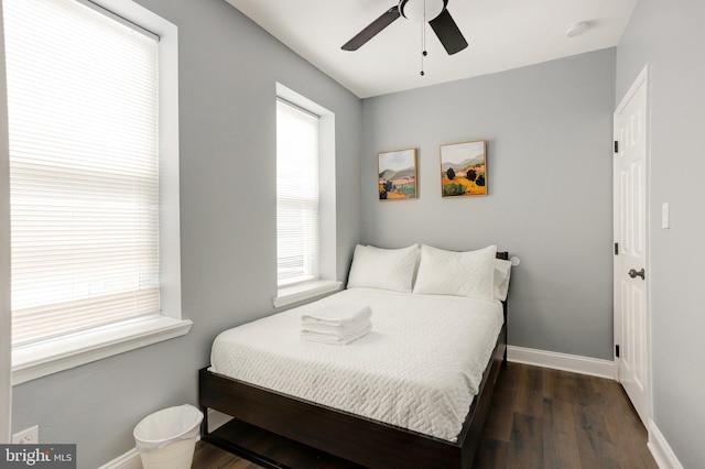 bedroom featuring a ceiling fan, baseboards, and wood finished floors