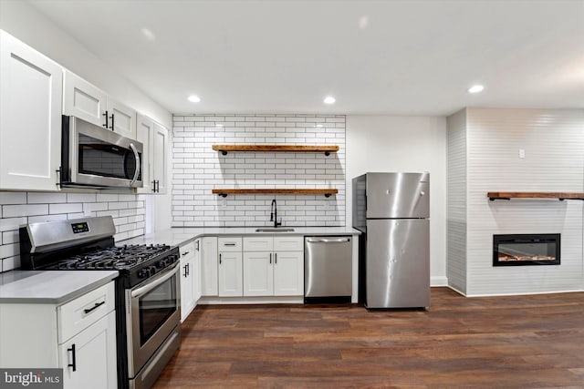 kitchen with white cabinets, appliances with stainless steel finishes, and dark wood finished floors