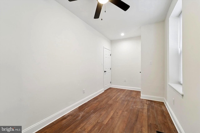 empty room featuring recessed lighting, dark wood finished floors, and baseboards