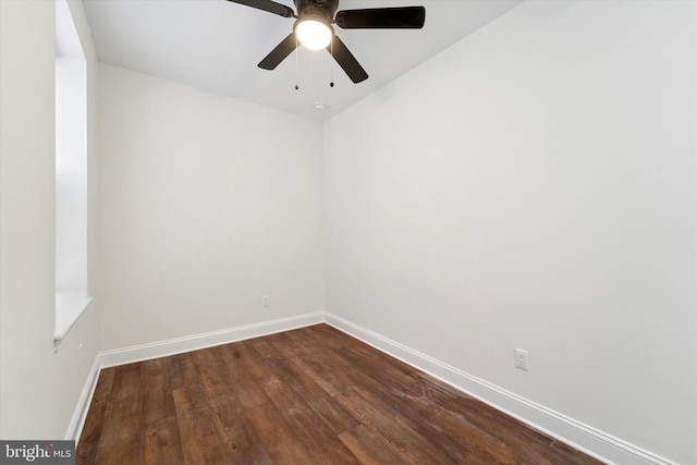 empty room with dark wood-type flooring, ceiling fan, and baseboards