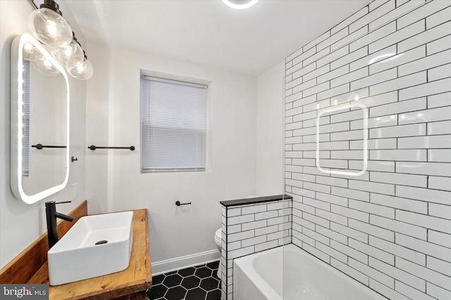 full bath featuring toilet, baseboards, and vanity