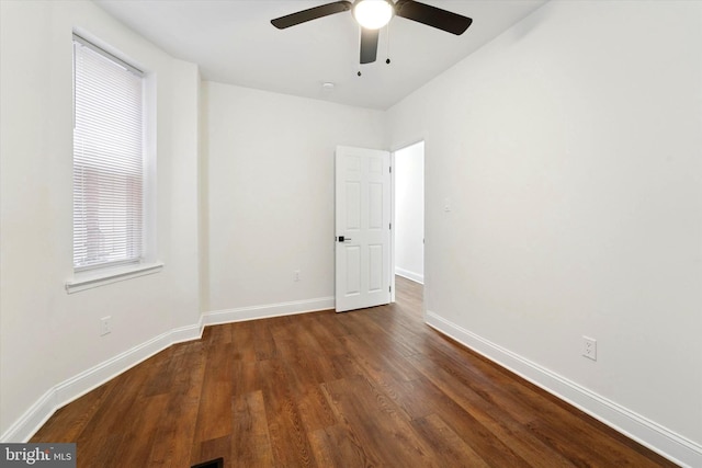 spare room with ceiling fan, baseboards, and wood finished floors