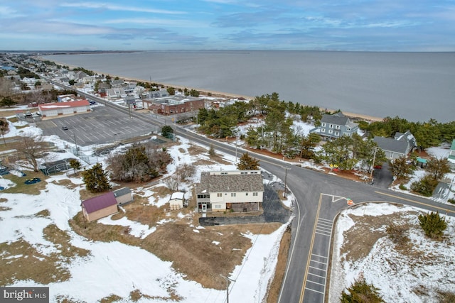 snowy aerial view featuring a water view