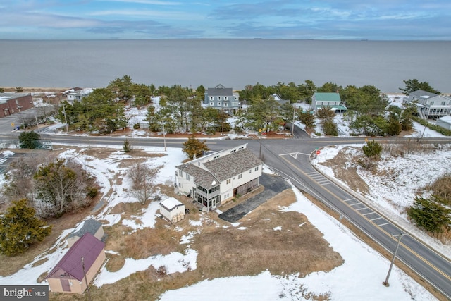 snowy aerial view featuring a water view