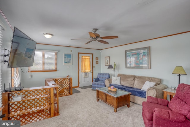 living room with ornamental molding, ceiling fan, baseboards, and carpet floors