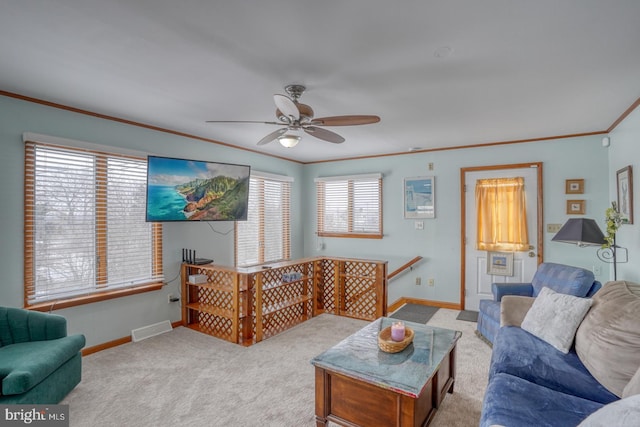 carpeted living room featuring visible vents, ceiling fan, crown molding, and baseboards