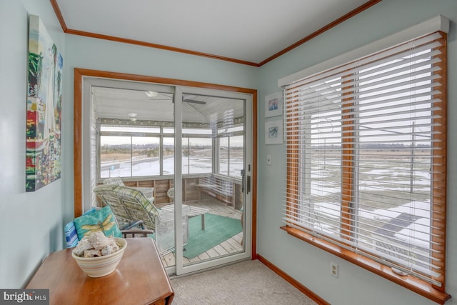 doorway featuring baseboards, carpet, and crown molding