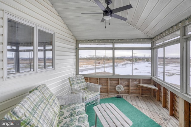 unfurnished sunroom with wooden ceiling, a ceiling fan, and vaulted ceiling