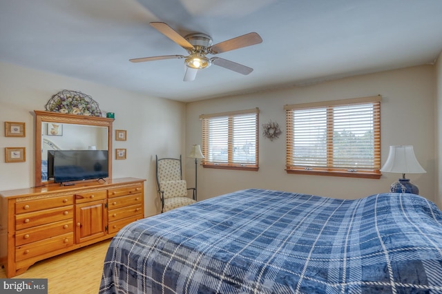 bedroom with ceiling fan and light wood-style flooring