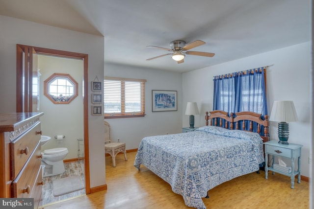 bedroom featuring connected bathroom, a ceiling fan, baseboards, and wood finished floors