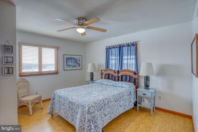 bedroom with wood finished floors, baseboards, and ceiling fan