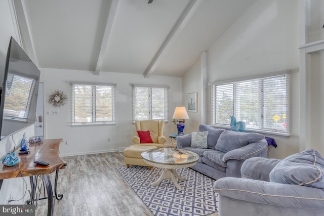 living room with lofted ceiling with beams, wood finished floors, and baseboards