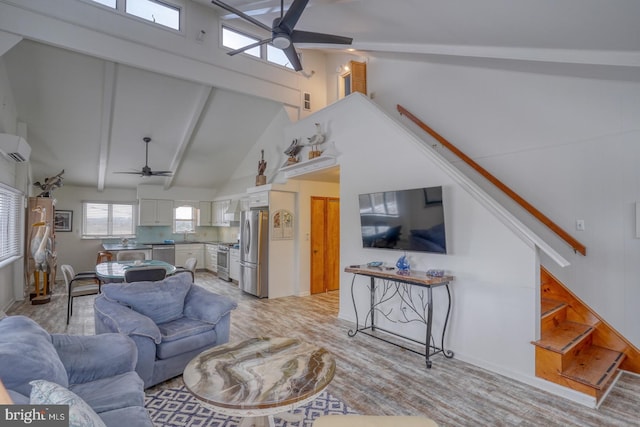 living room with ceiling fan, stairway, a wall mounted air conditioner, beam ceiling, and high vaulted ceiling