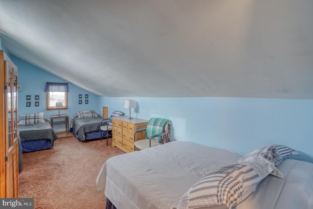 bedroom with light colored carpet and vaulted ceiling