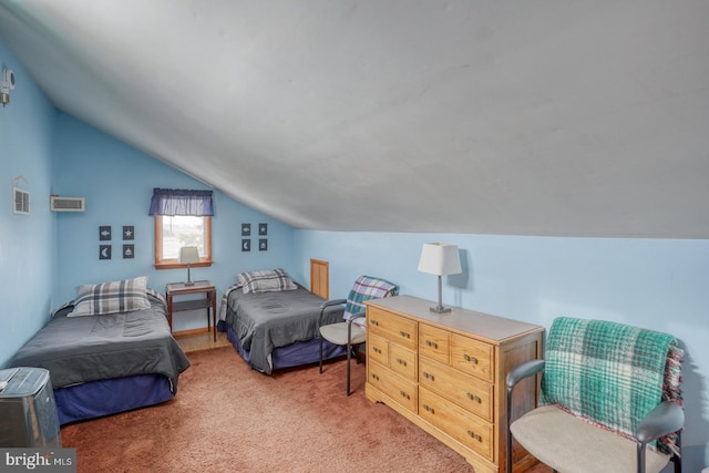 bedroom featuring vaulted ceiling, light colored carpet, and visible vents