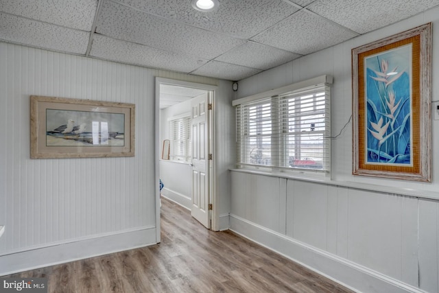 unfurnished room featuring a paneled ceiling and wood finished floors