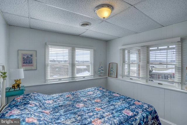 bedroom with visible vents and a paneled ceiling