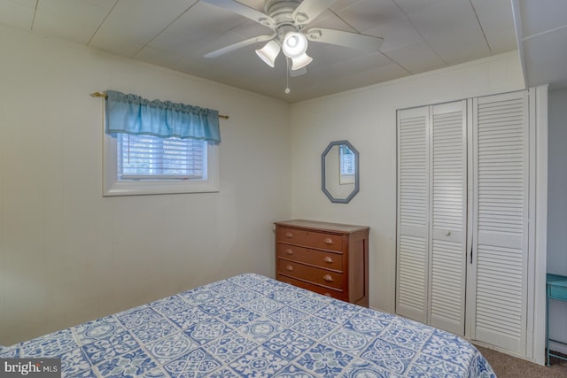 carpeted bedroom with a closet and ceiling fan