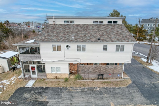 view of front of home with a sunroom