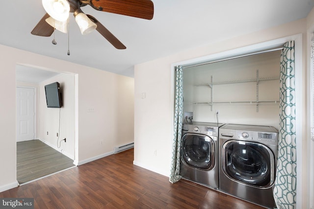 washroom with washing machine and dryer, a baseboard heating unit, laundry area, wood finished floors, and baseboards