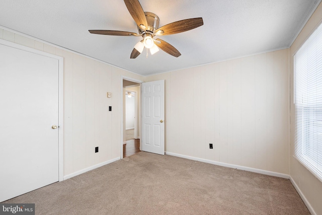 unfurnished bedroom featuring light carpet and ceiling fan