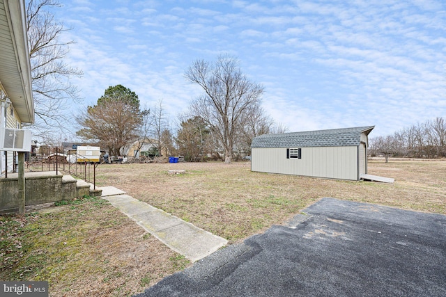 view of yard featuring a storage unit and an outbuilding