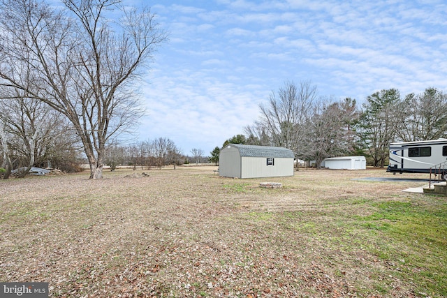 view of yard featuring an outbuilding and a shed