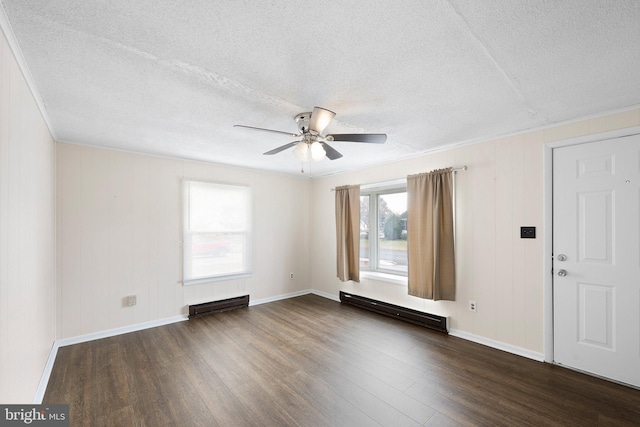 spare room with a baseboard heating unit, ceiling fan, dark wood-style flooring, and a textured ceiling