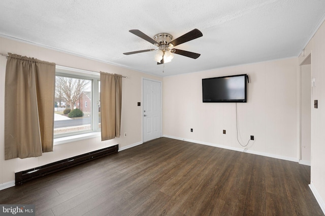 unfurnished living room with a ceiling fan, baseboards, a baseboard heating unit, and wood finished floors