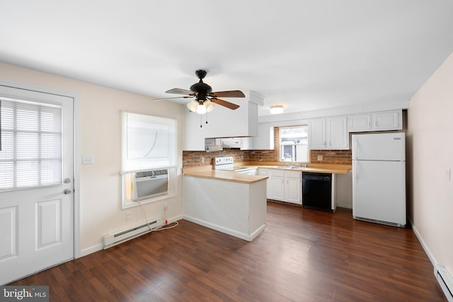 kitchen featuring white appliances, a baseboard radiator, a peninsula, light countertops, and a sink