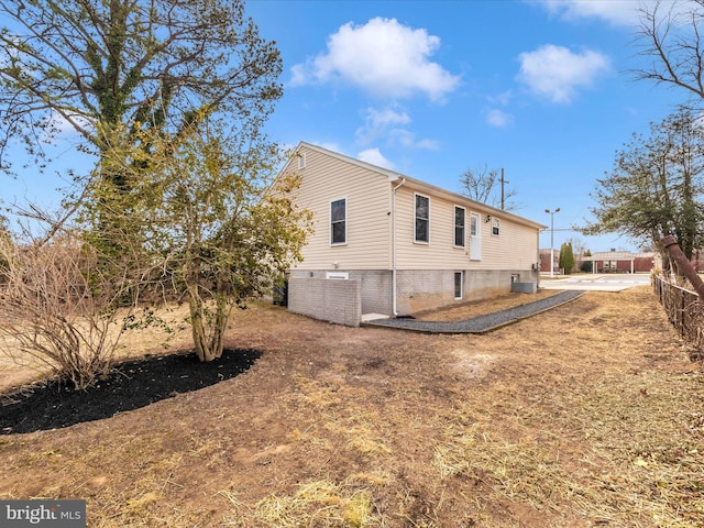 back of property with fence and central air condition unit