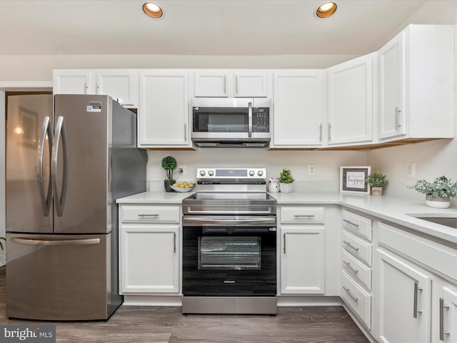 kitchen with appliances with stainless steel finishes and white cabinetry