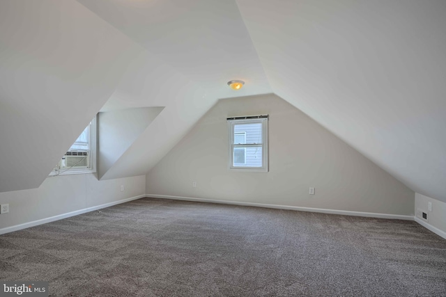 bonus room with lofted ceiling, baseboards, and carpet floors