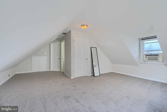 additional living space with baseboards, cooling unit, carpet floors, and visible vents