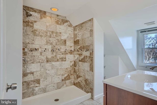 full bath featuring tile patterned flooring, vanity, visible vents, and a stall shower