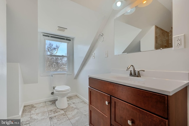 bathroom with visible vents, toilet, vanity, and baseboards