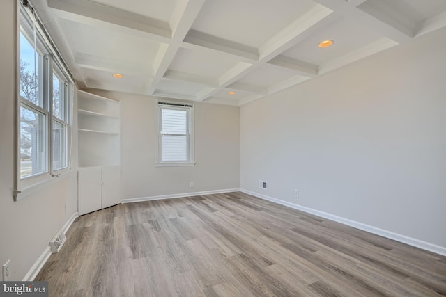 spare room with beamed ceiling, baseboards, coffered ceiling, and wood finished floors