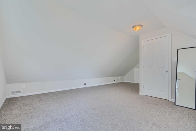 bonus room featuring visible vents, lofted ceiling, and carpet floors