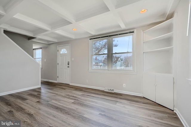 foyer with visible vents, coffered ceiling, baseboards, and wood finished floors